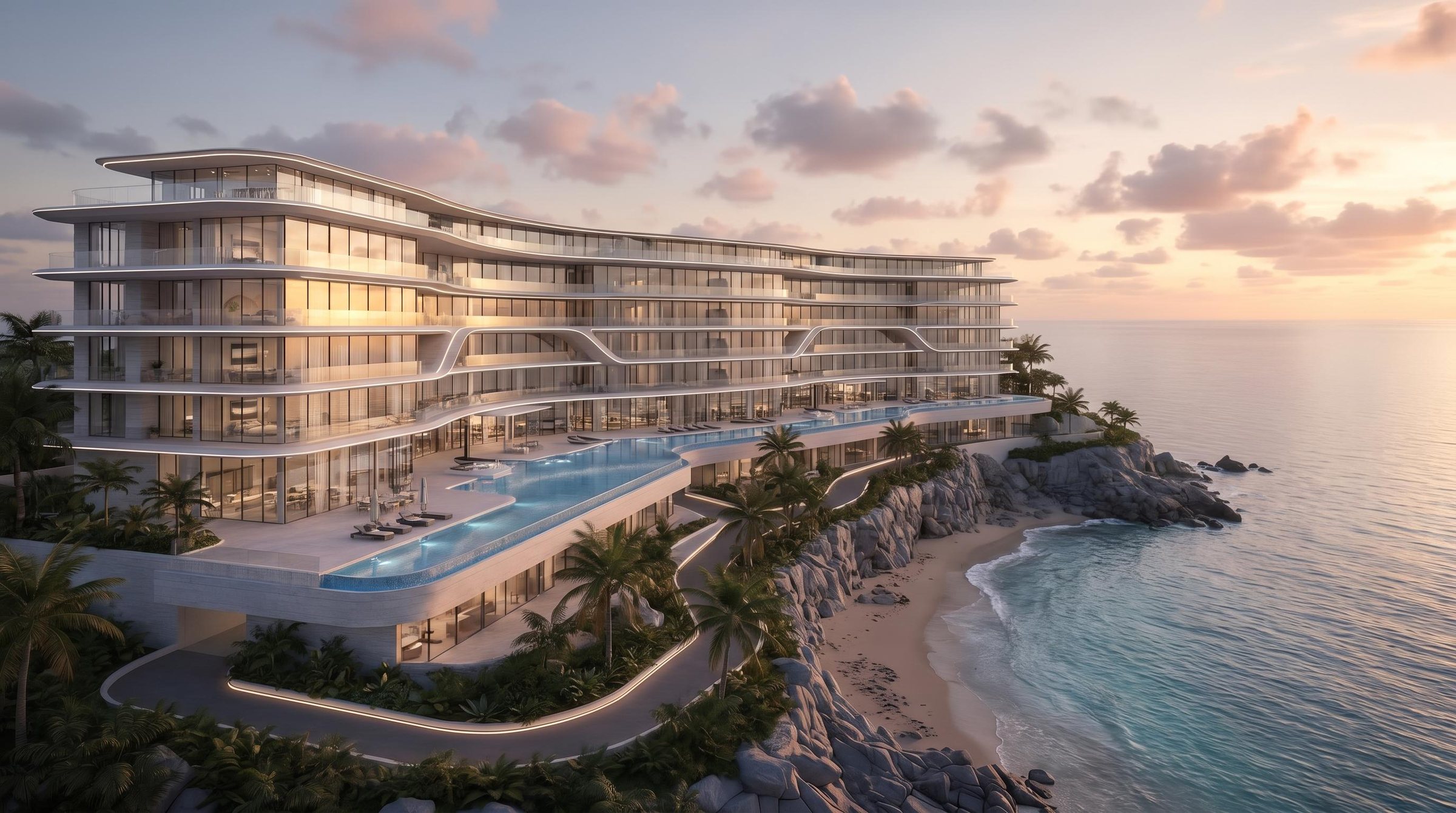 A large curved resort development at sunset overlooking the sea